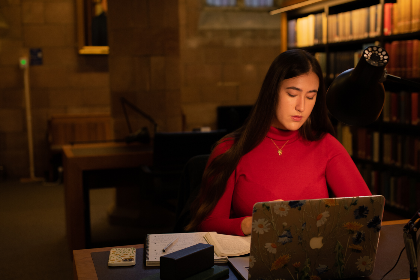 A PG student studying at a single seat desk in the Thomson Reading Room